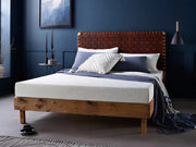 A Coolmax Classic Memory Foam Mattress on a bed frame, with a cooling mattress cover, in a bedroom setting.
